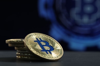 Photo of Cryptocurrency. Golden bitcoins on grey table, closeup