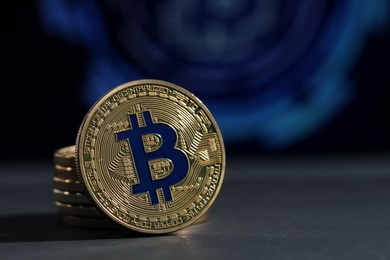 Photo of Cryptocurrency. Golden bitcoins on grey table, closeup. Space for text