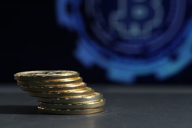 Photo of Cryptocurrency. Golden bitcoins on grey table, closeup. Space for text