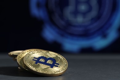 Photo of Cryptocurrency. Golden bitcoins on grey table, closeup. Space for text