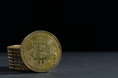 Photo of Cryptocurrency. Golden bitcoins on grey table, closeup. Space for text
