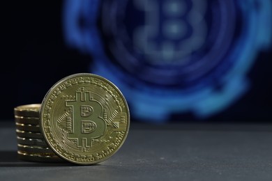 Photo of Cryptocurrency. Golden bitcoins on grey table, closeup. Space for text