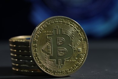 Photo of Cryptocurrency. Golden bitcoins on grey table, closeup