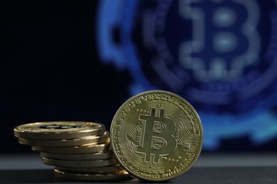 Photo of Cryptocurrency. Golden bitcoins on grey table, closeup