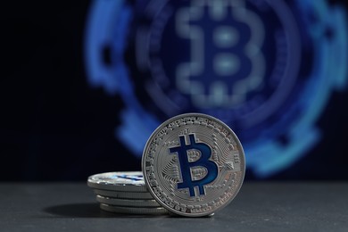 Photo of Cryptocurrency. Silver bitcoins on grey table, closeup