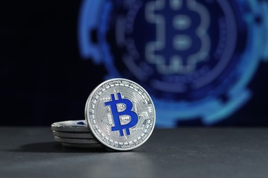 Photo of Cryptocurrency. Silver bitcoins on grey table, closeup. Space for text