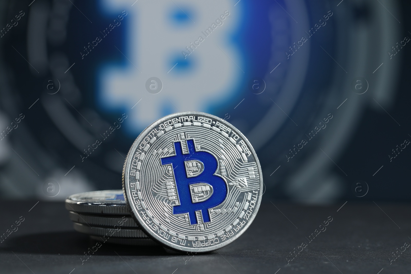 Cryptocurrency. Silver bitcoins on grey table, closeup Photo of Cryptocurrency. Silver bitcoins on grey table, closeup