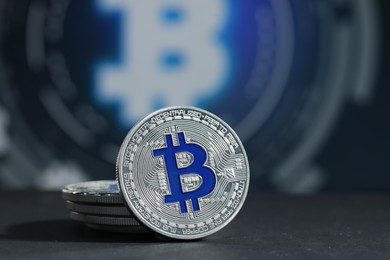 Photo of Cryptocurrency. Silver bitcoins on grey table, closeup