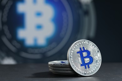 Photo of Cryptocurrency. Silver bitcoins on grey table, closeup. Space for text