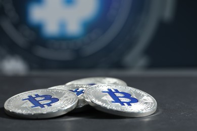 Photo of Cryptocurrency. Silver bitcoins on grey table, closeup