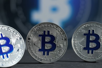 Photo of Cryptocurrency. Silver bitcoins on grey table, closeup