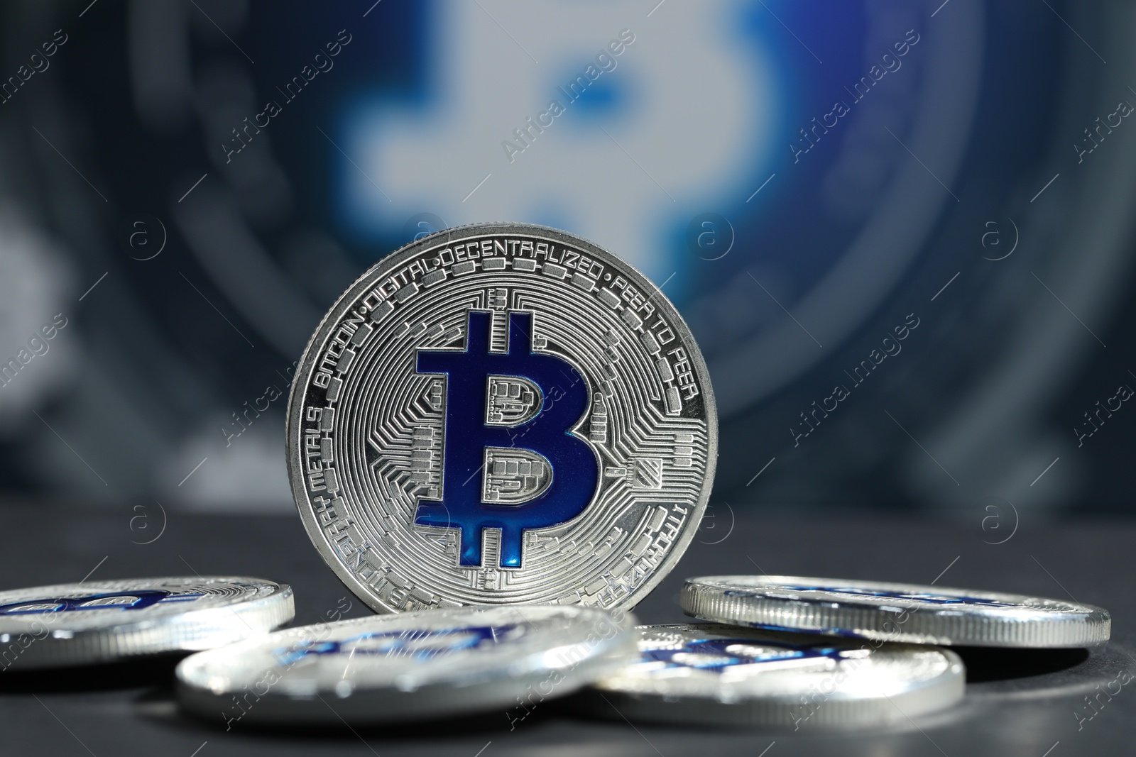 Cryptocurrency. Silver bitcoins on grey table, closeup Photo of Cryptocurrency. Silver bitcoins on grey table, closeup