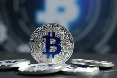 Photo of Cryptocurrency. Silver bitcoins on grey table, closeup