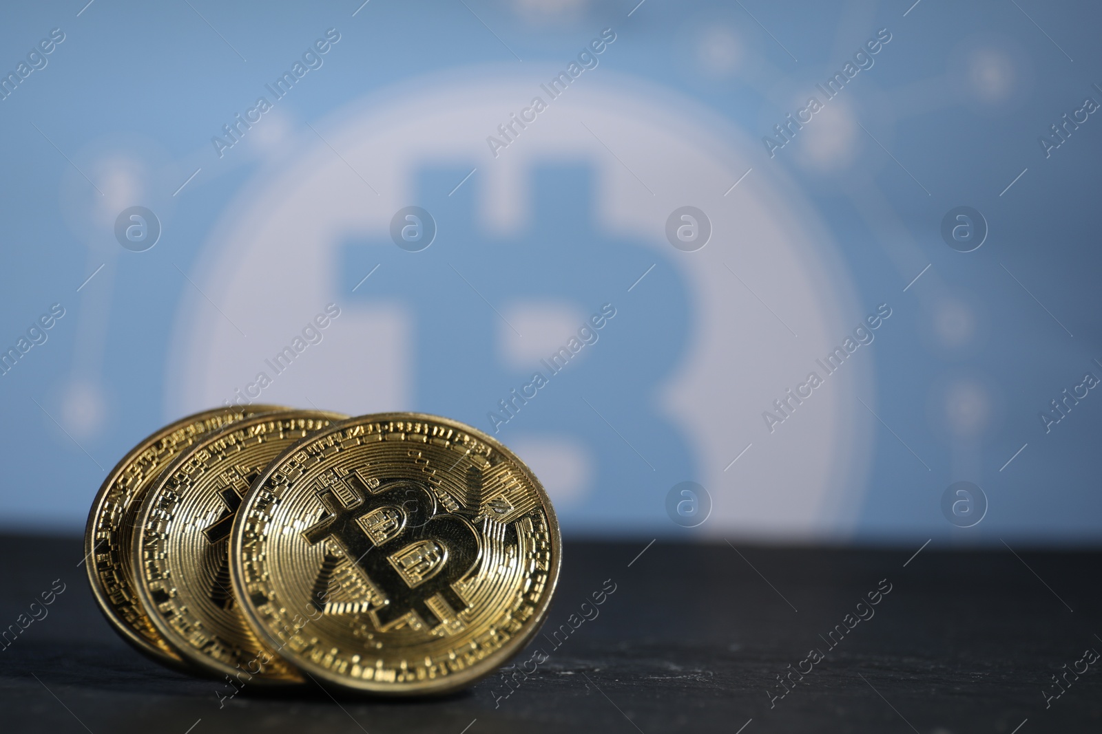 Cryptocurrency. Three bitcoins on black table, closeup. Space for text Photo of Cryptocurrency. Three bitcoins on black table, closeup. Space for text