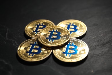 Photo of Cryptocurrency. Bitcoins on black table, closeup view