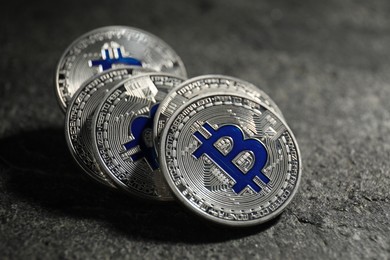 Photo of Cryptocurrency. Silver bitcoins on grey table, closeup
