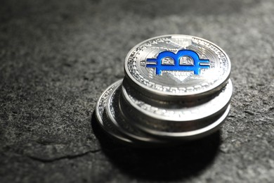 Photo of Cryptocurrency. Bitcoins on grey table, closeup. Space for text