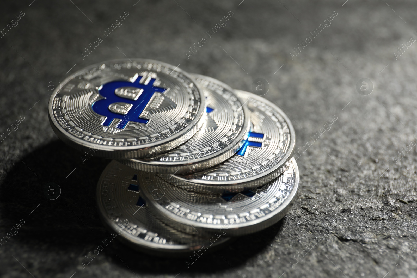 Cryptocurrency. Silver bitcoins on grey table, closeup Photo of Cryptocurrency. Silver bitcoins on grey table, closeup