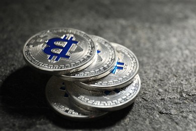 Photo of Cryptocurrency. Silver bitcoins on grey table, closeup
