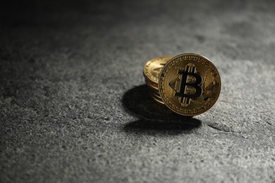 Photo of Cryptocurrency. Bitcoins on grey table, closeup. Space for text