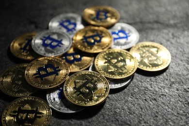 Photo of Cryptocurrency. Different bitcoins on grey table, closeup