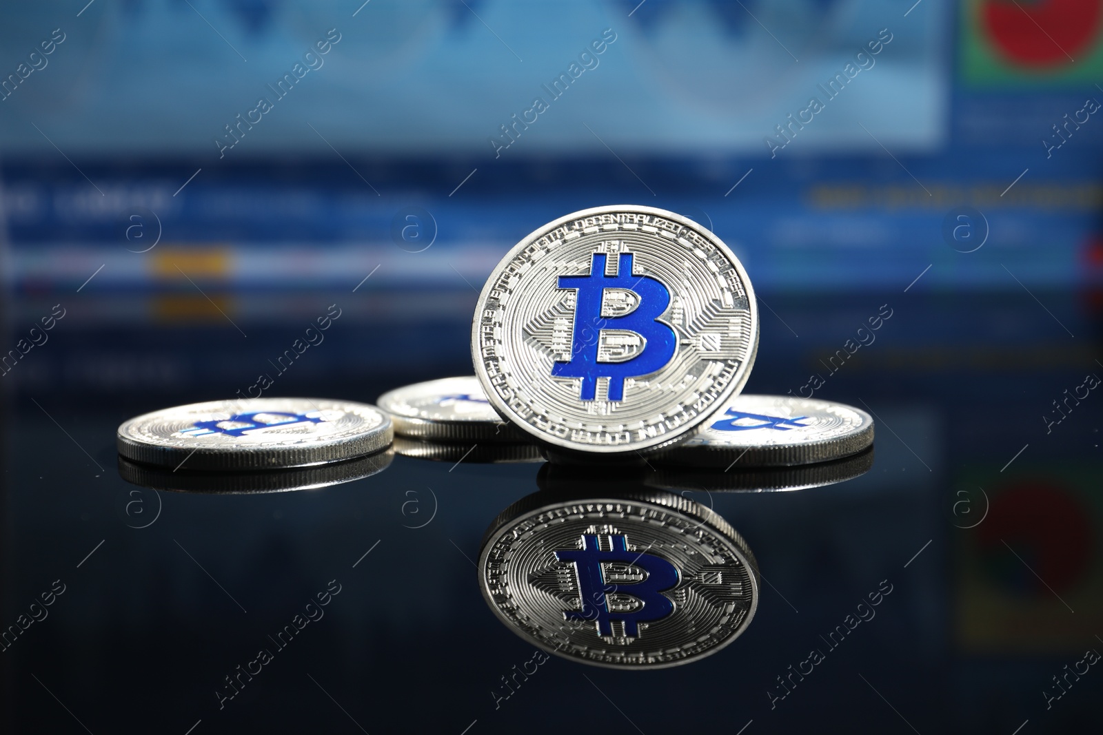 Cryptocurrency. Silver bitcoins on mirror surface, closeup Photo of Cryptocurrency. Silver bitcoins on mirror surface, closeup