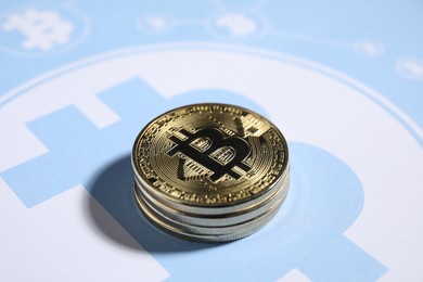 Photo of Stack of bitcoins on cryptocurrency symbol, closeup