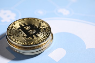 Photo of Stack of bitcoins on cryptocurrency symbol, closeup. Space for text