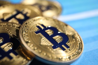 Photo of Cryptocurrency. Golden bitcoins on color background, closeup