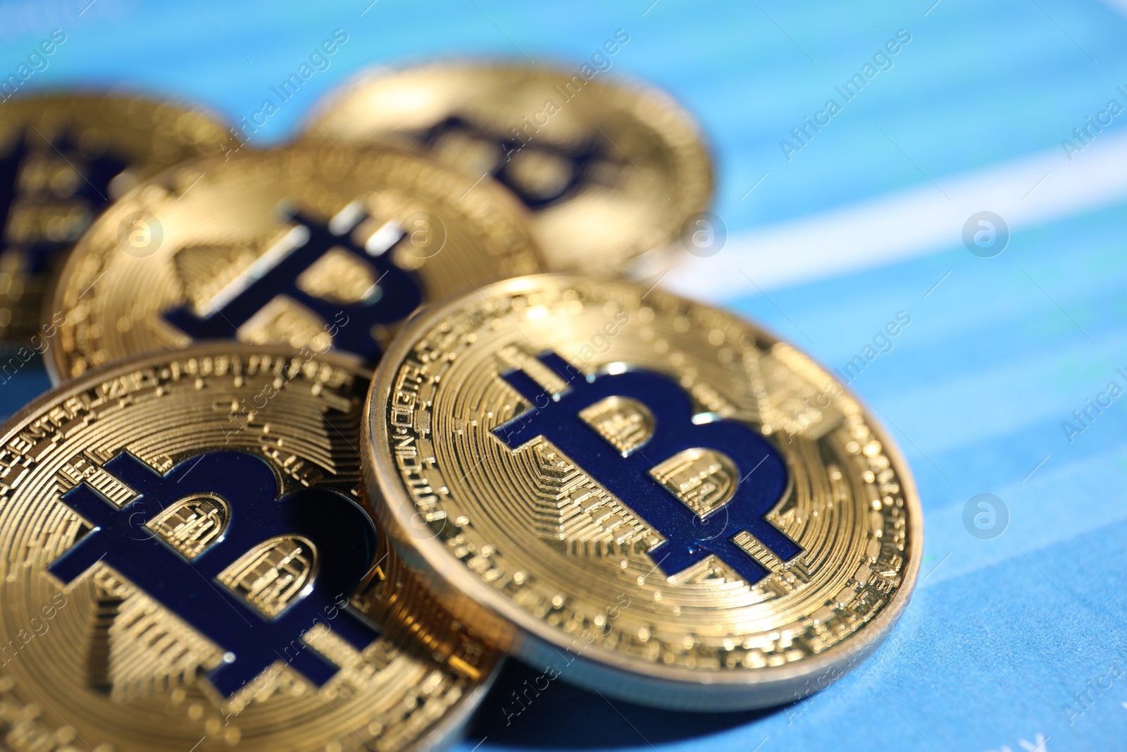 Cryptocurrency. Golden bitcoins on data charts, closeup Photo of Cryptocurrency. Golden bitcoins on data charts, closeup