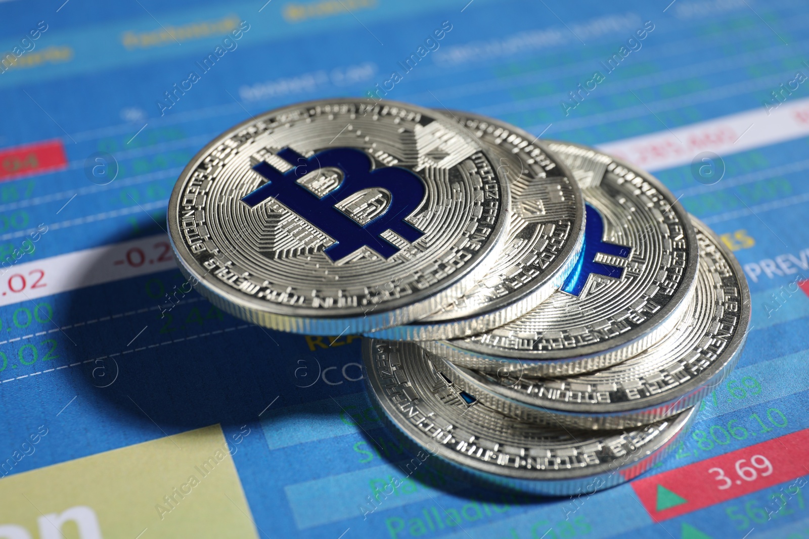 Cryptocurrency. Silver bitcoins on data charts, closeup Photo of Cryptocurrency. Silver bitcoins on data charts, closeup