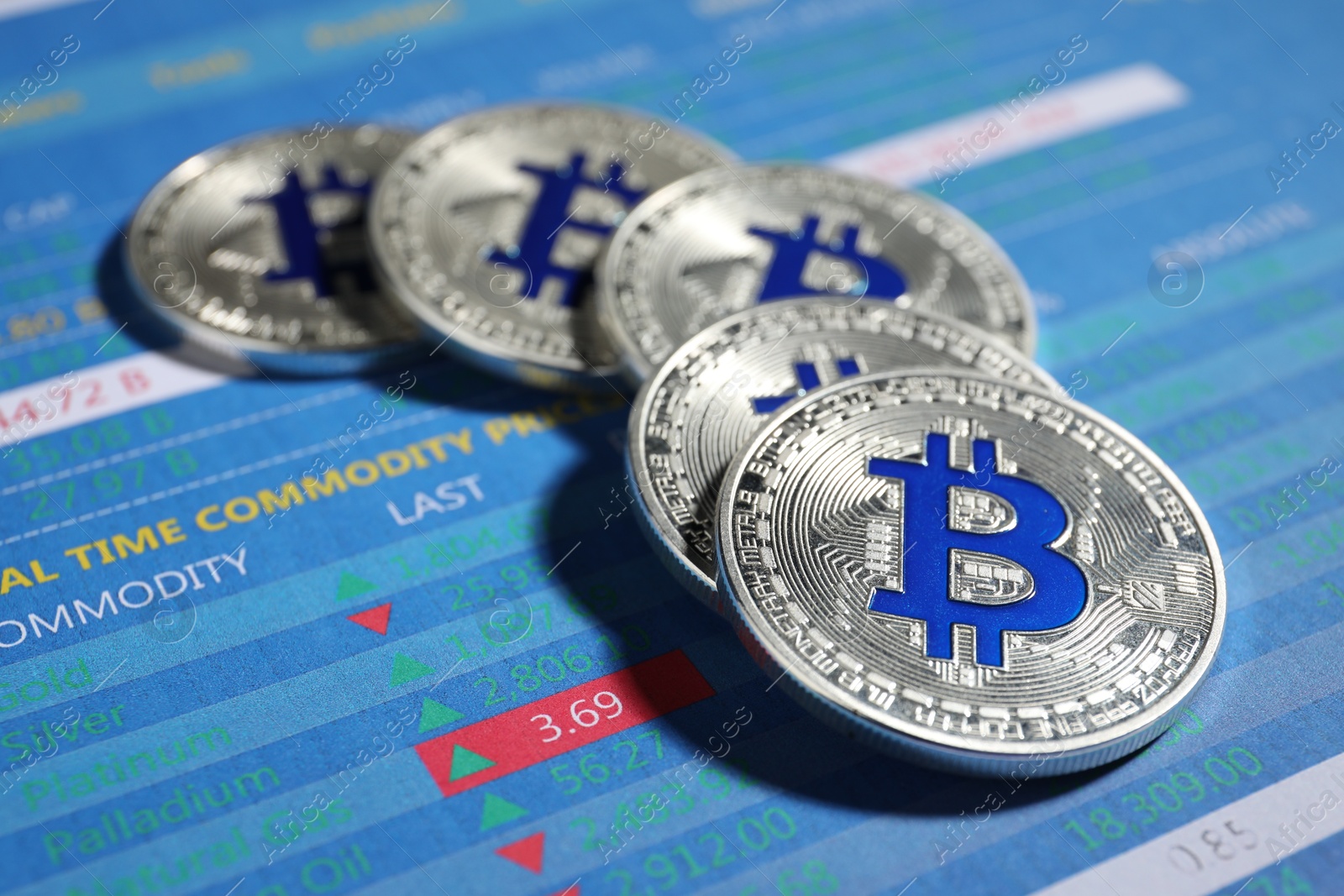 Cryptocurrency. Silver bitcoins on data charts, closeup Photo of Cryptocurrency. Silver bitcoins on data charts, closeup