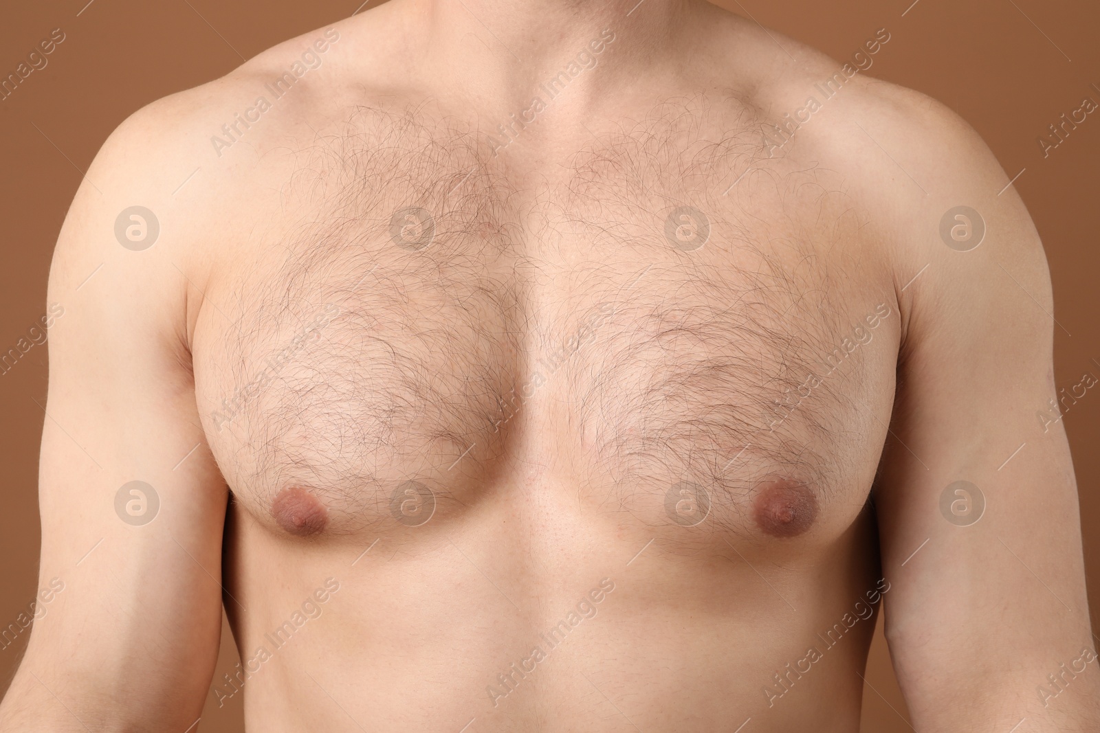Young man with hairy chest on brown background, closeup. Epilation procedure Photo of Young man with hairy chest on brown background, closeup. Epilation procedure