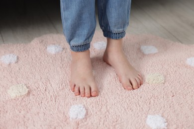 Photo of Girl on soft carpet at home, closeup