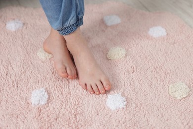 Photo of Girl on soft carpet at home, closeup