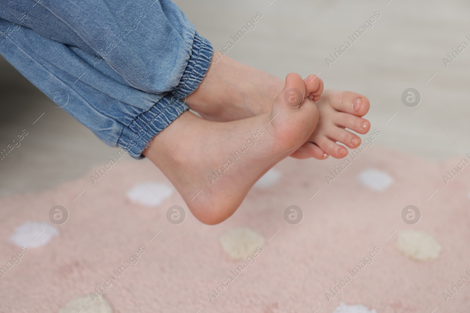 Girl above soft carpet at home, closeup Photo of Girl above soft carpet at home, closeup