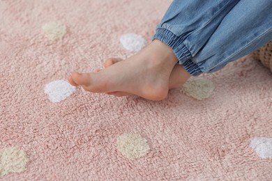 Photo of Girl on soft carpet at home, closeup