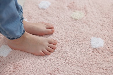 Photo of Girl on soft carpet at home, closeup