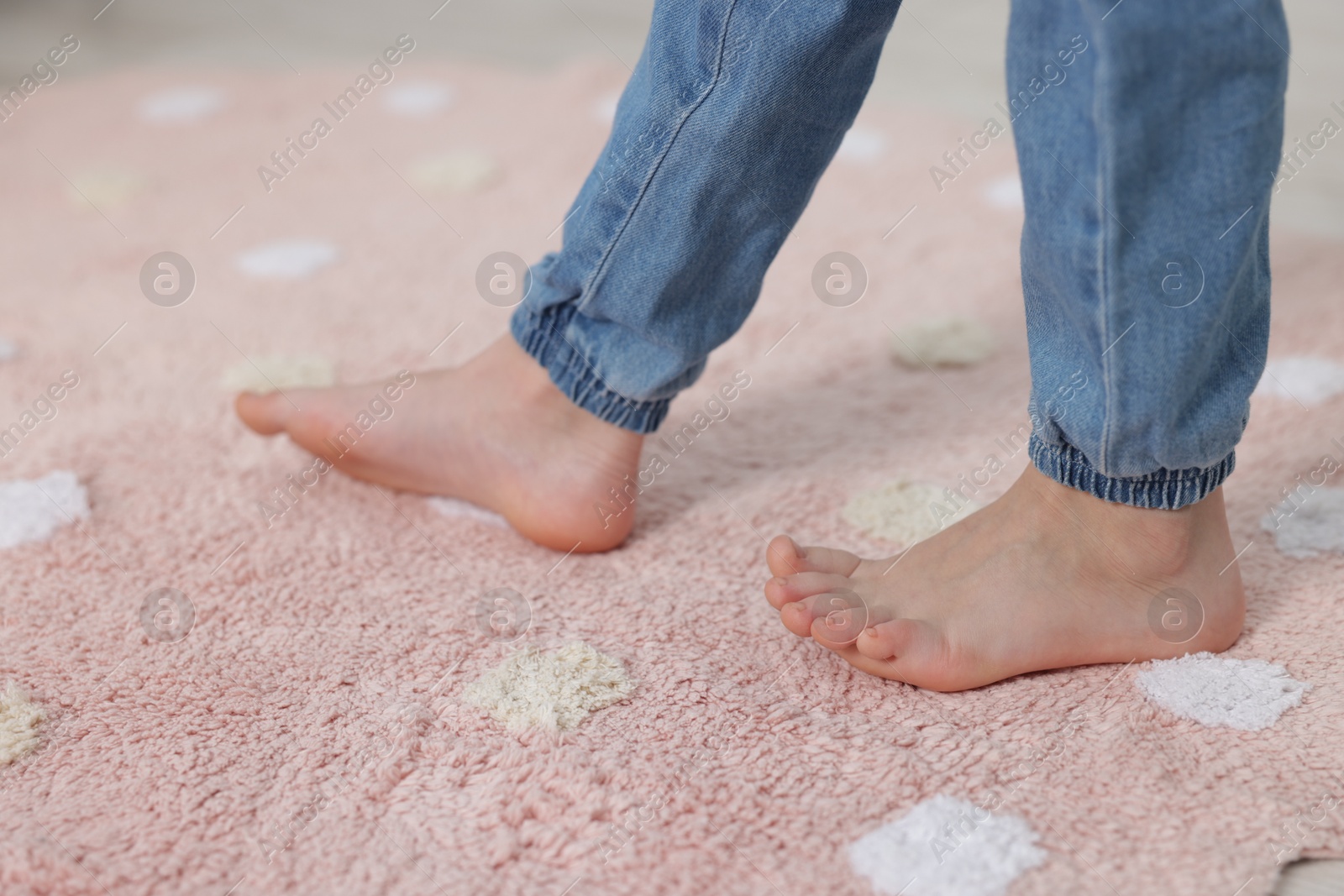 Girl walking on soft carpet at home, closeup Photo of Girl walking on soft carpet at home, closeup