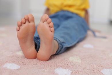 Photo of Girl on soft carpet at home, closeup