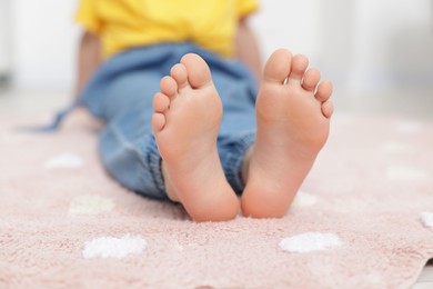 Photo of Girl on soft carpet at home, closeup