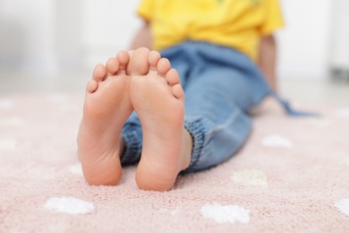 Photo of Girl on soft carpet at home, closeup