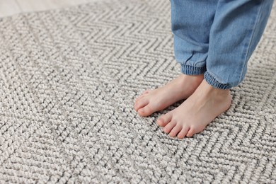 Photo of Girl on grey carpet at home, closeup. Space for text