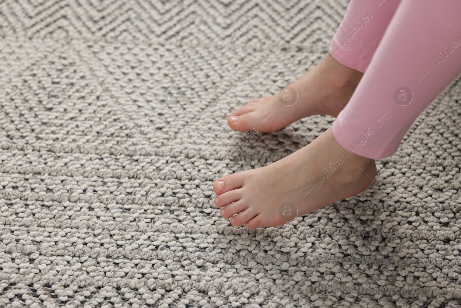 Girl above grey carpet at home, closeup Photo of Girl above grey carpet at home, closeup