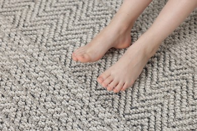 Photo of Girl on grey carpet at home, above view