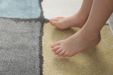 Photo of Girl on soft carpet at home, closeup