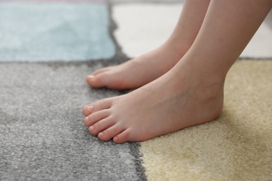 Photo of Girl on soft carpet at home, closeup
