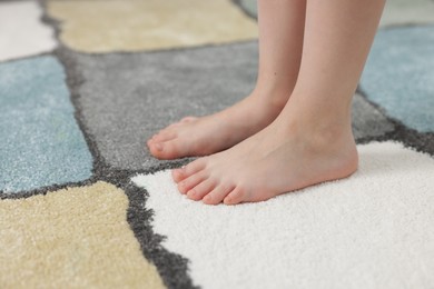 Photo of Girl on soft carpet at home, closeup
