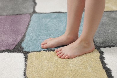 Photo of Girl on soft carpet at home, closeup