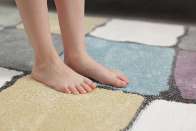 Photo of Girl on soft carpet at home, closeup